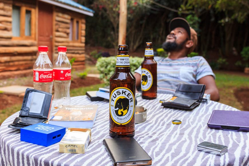 Tourist enjoys the local beer Tusker