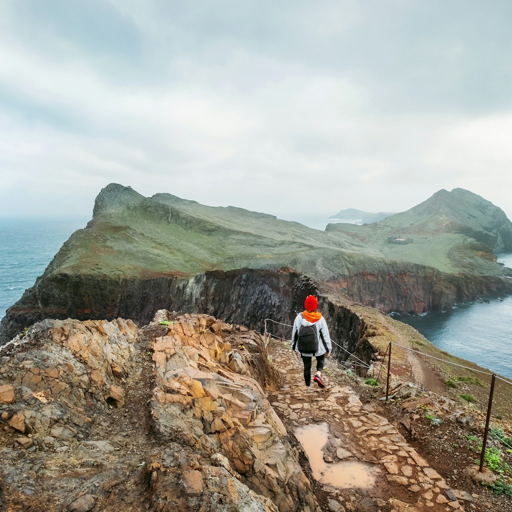 A young woman explores the coastline of Madeira 