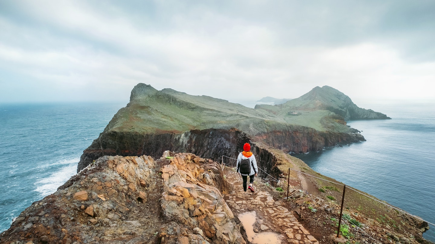 A young woman explores the coastline of Madeira 