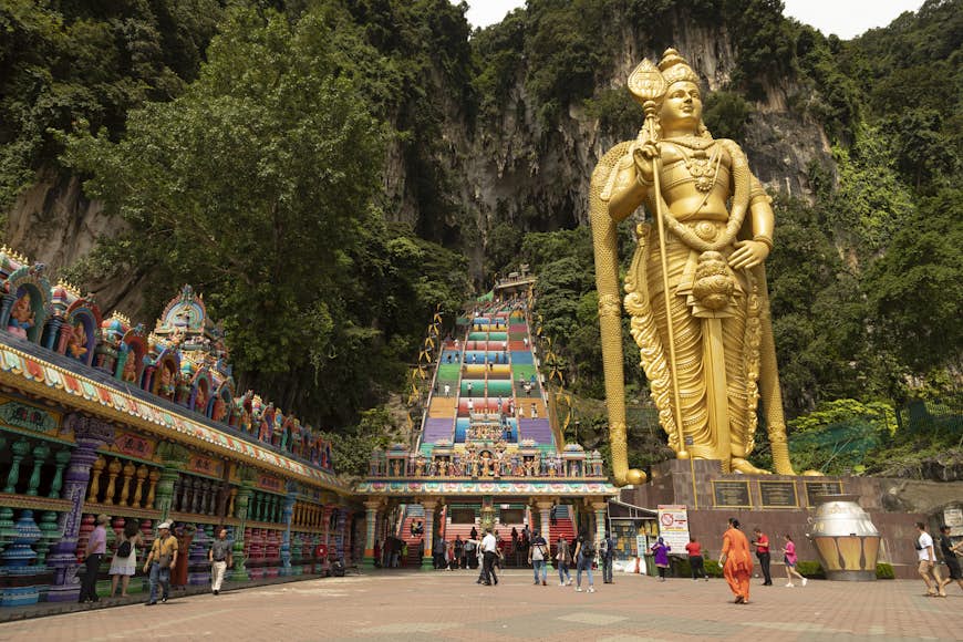 Access area and entrance to the stairs to the Batu Caves, guarded by the huge Sri Muruga statue, Gombak District, Selangor, Malaysia 