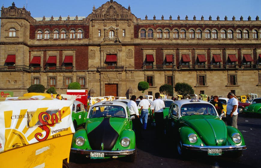 VW taxis wait near the Zocalo, in front of the National Palace for a passing fare