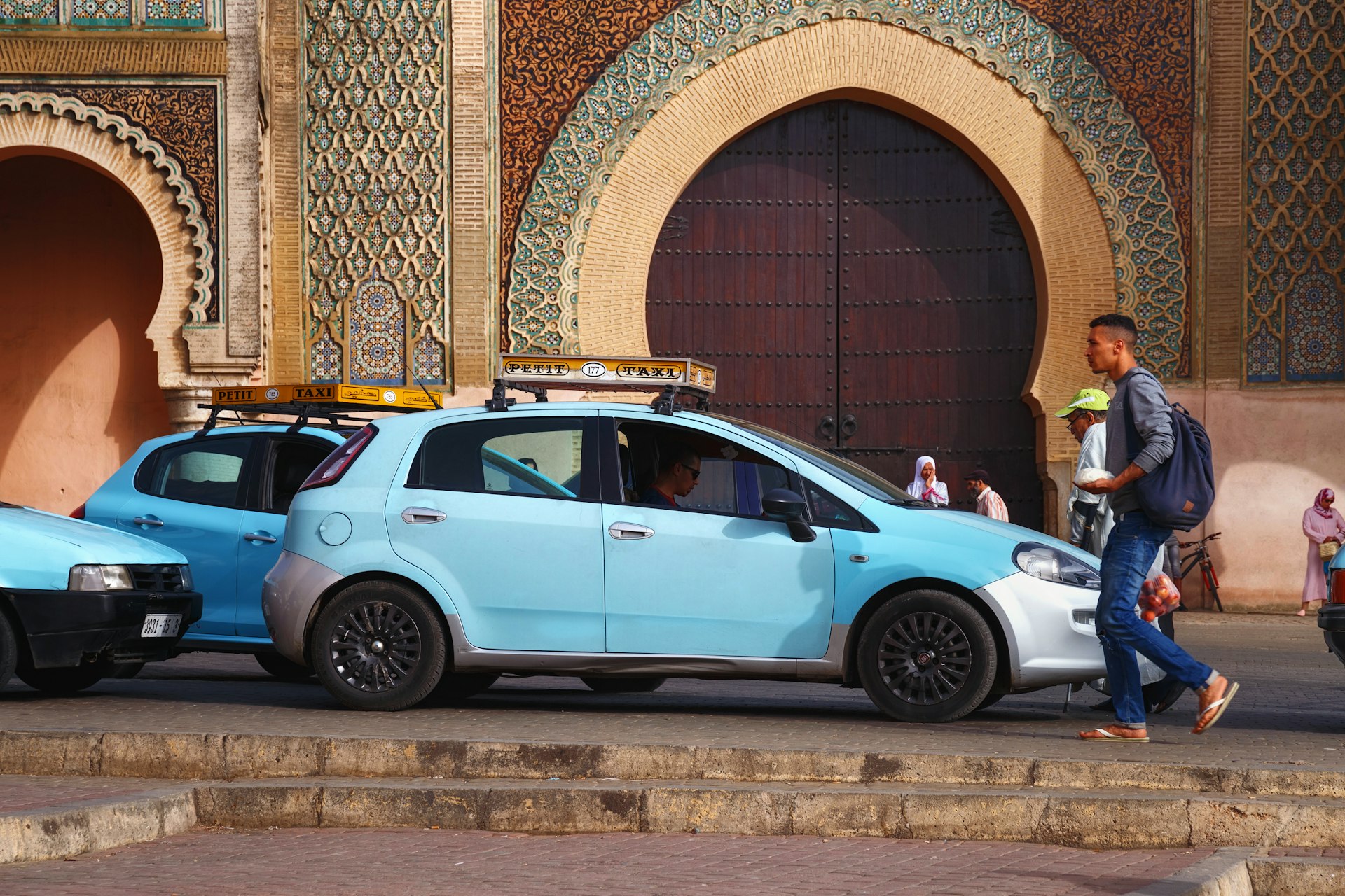 Blue petit taxi car near Bab Mansour Gate in Meknes, Morocco