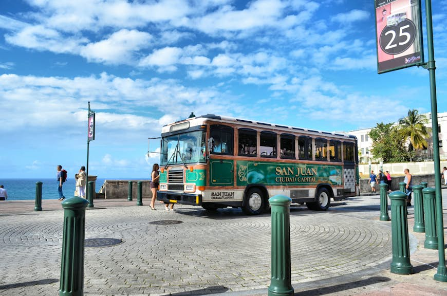 An old bus driving through San Juan in Puerto Rico