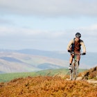A young man rides on a purpose built trail across a moor in the Scottish Borders