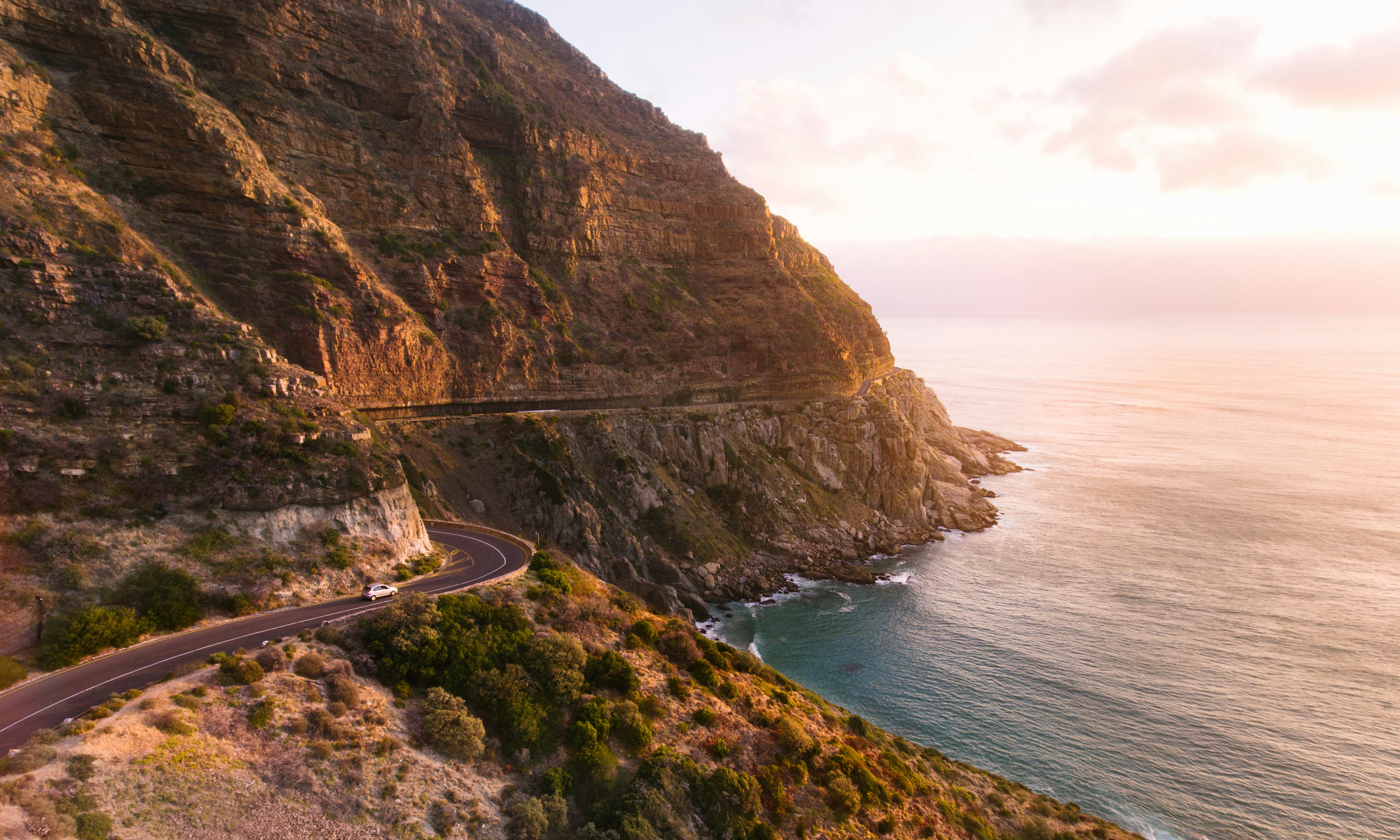 A car follow a coastal road