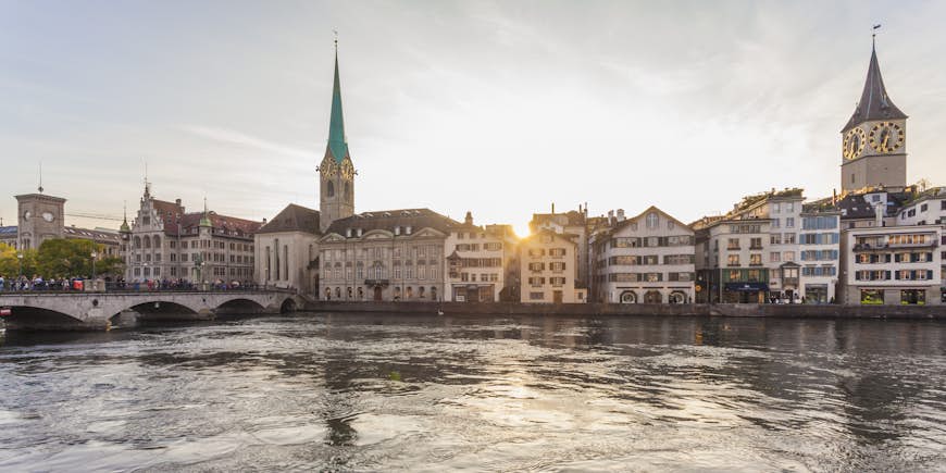 Church of Fraumünster and the Zürich skyline in the evening behind the Limmat River