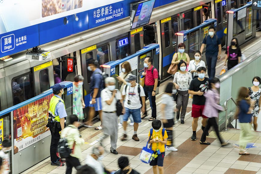 Commuters are shuttled inside the Zhongxiao Xinsheng Station of the Taipei MRT in Taiwan at rush hour