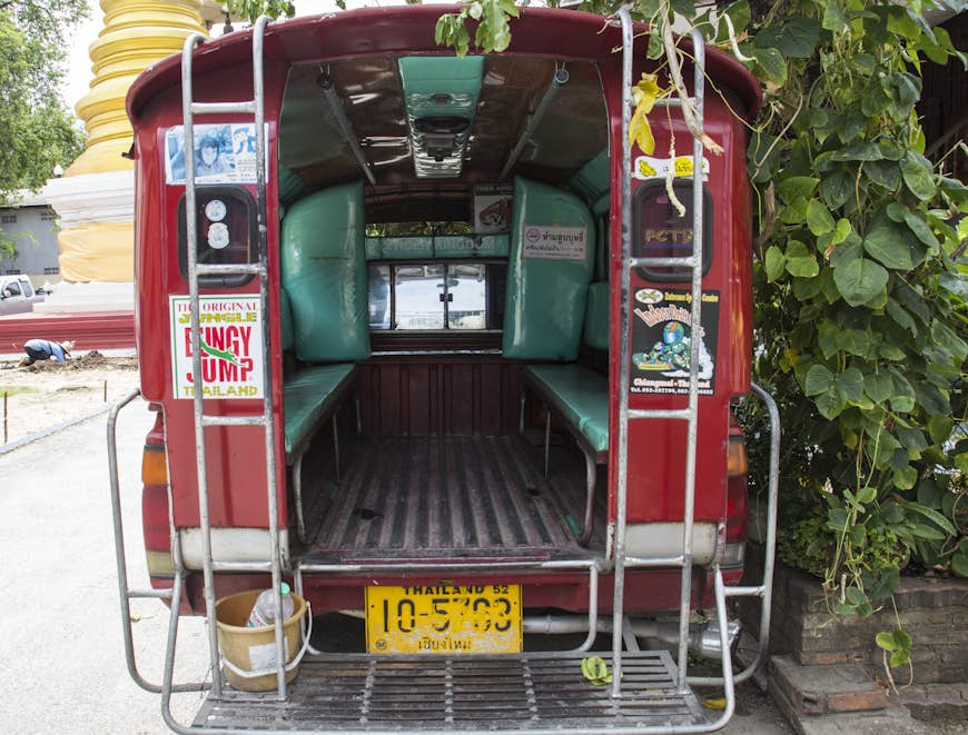 A view of the interior of a red minibus from the back in Chiang Mai, Thailand
