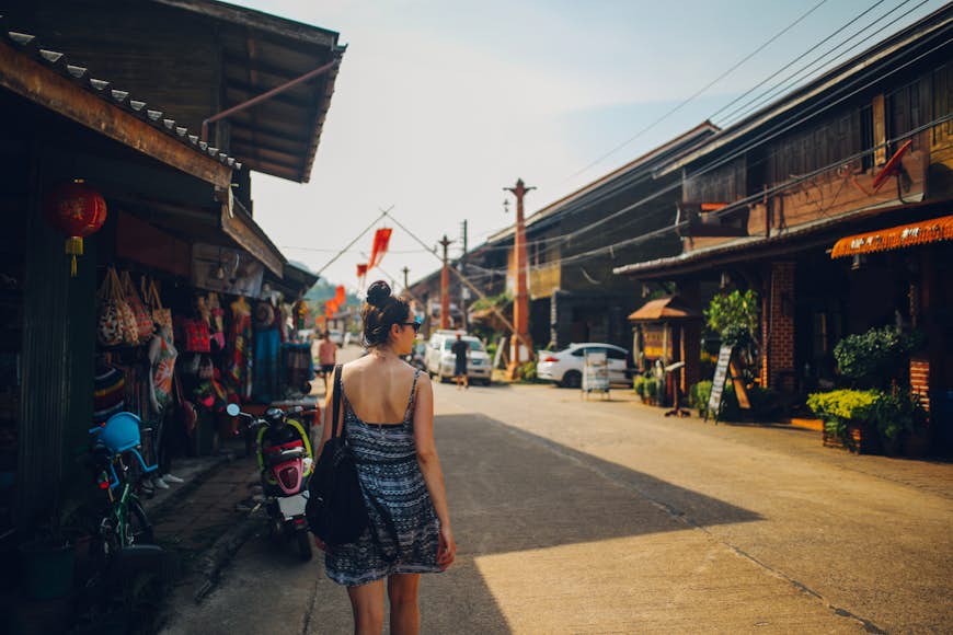 Young woman walking in the Old Town of the Koh Lanta island, Thailand