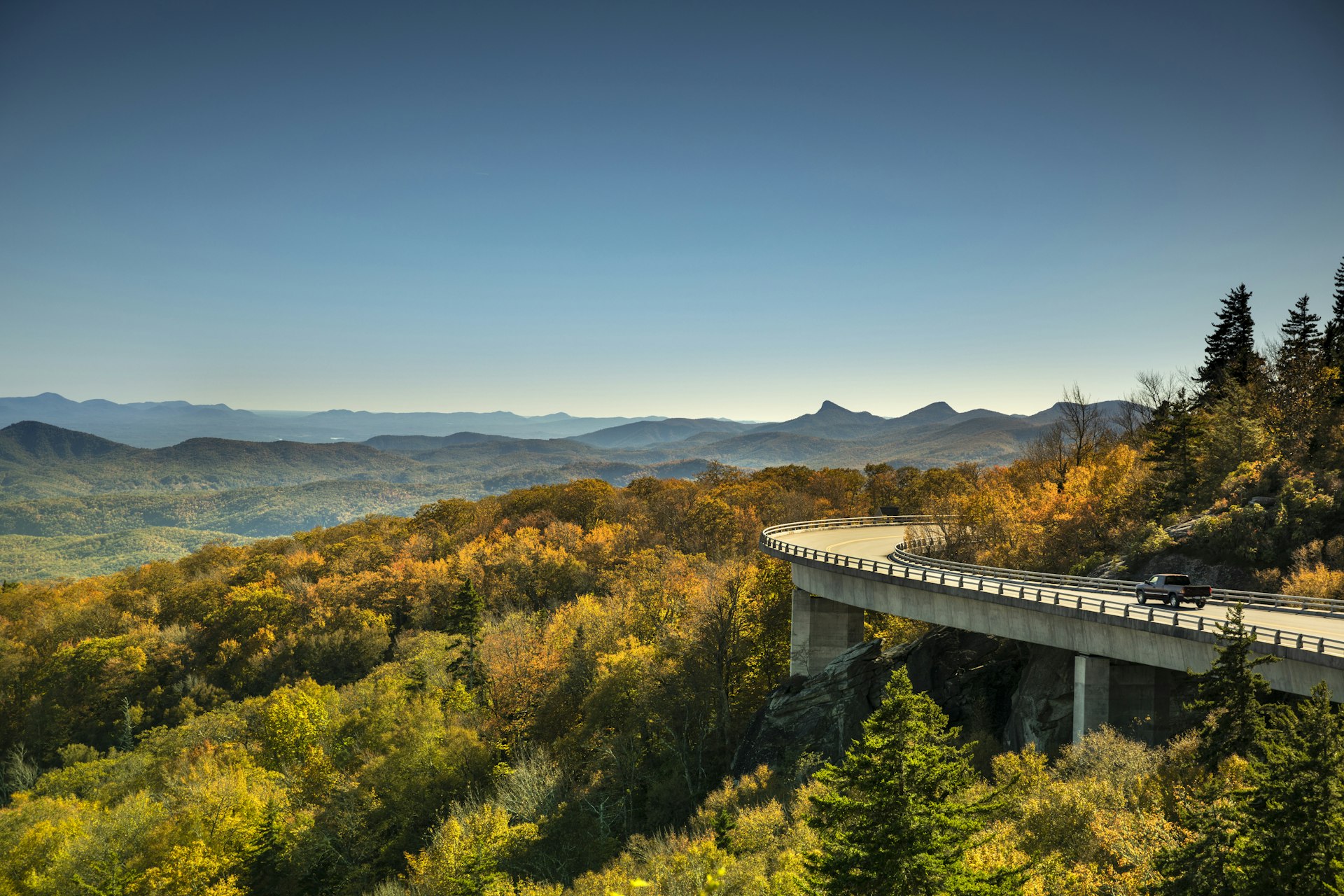 Cars travel on the Linn Cove Viaduct highway road on the Grandfather Mountain along the Blue Ridge Parkway in autumn North Carolina