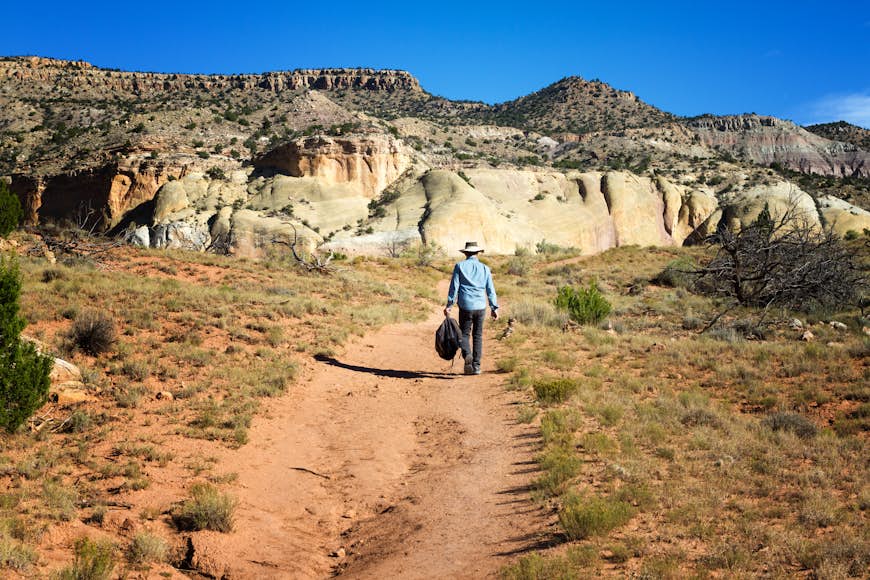 Senior man hiking on a red trail at Ghost Ranch in New Mexico