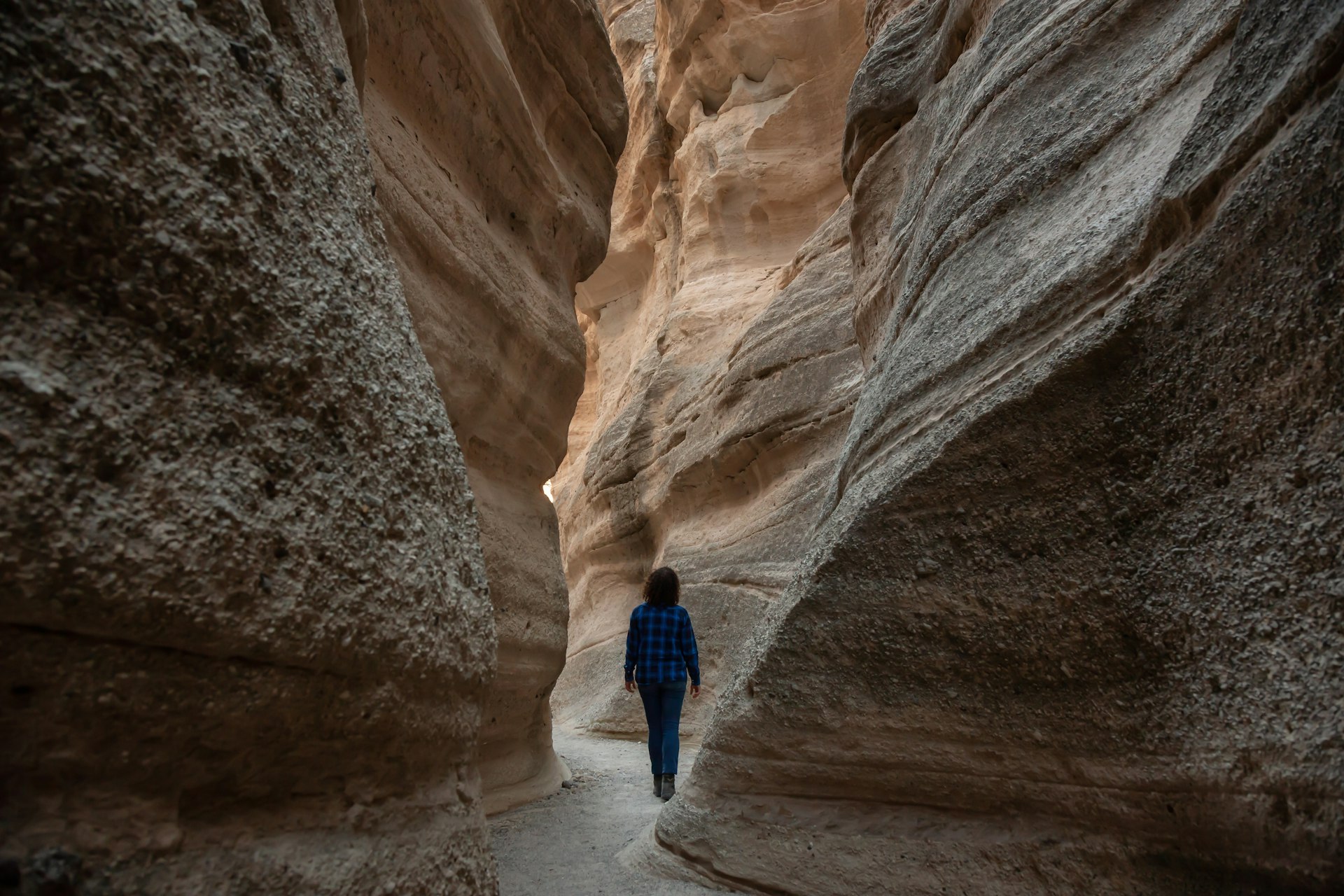 Woman hiking on a sunny evening in the beautiful canyon landscape of Kasha-Katuwe Tent Rocks National Monument, New Mexico, 