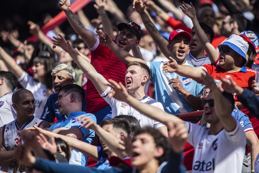 Nacional fans raise their arms and cheer in the stands of the Gran Parque Central stadium, Montevideo, Uruguay, South America