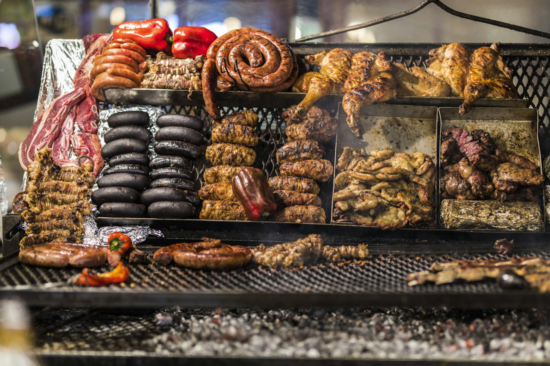 Sausages and other meets cook on an asado grill in Central Market, Montevideo, Uruguay, South America