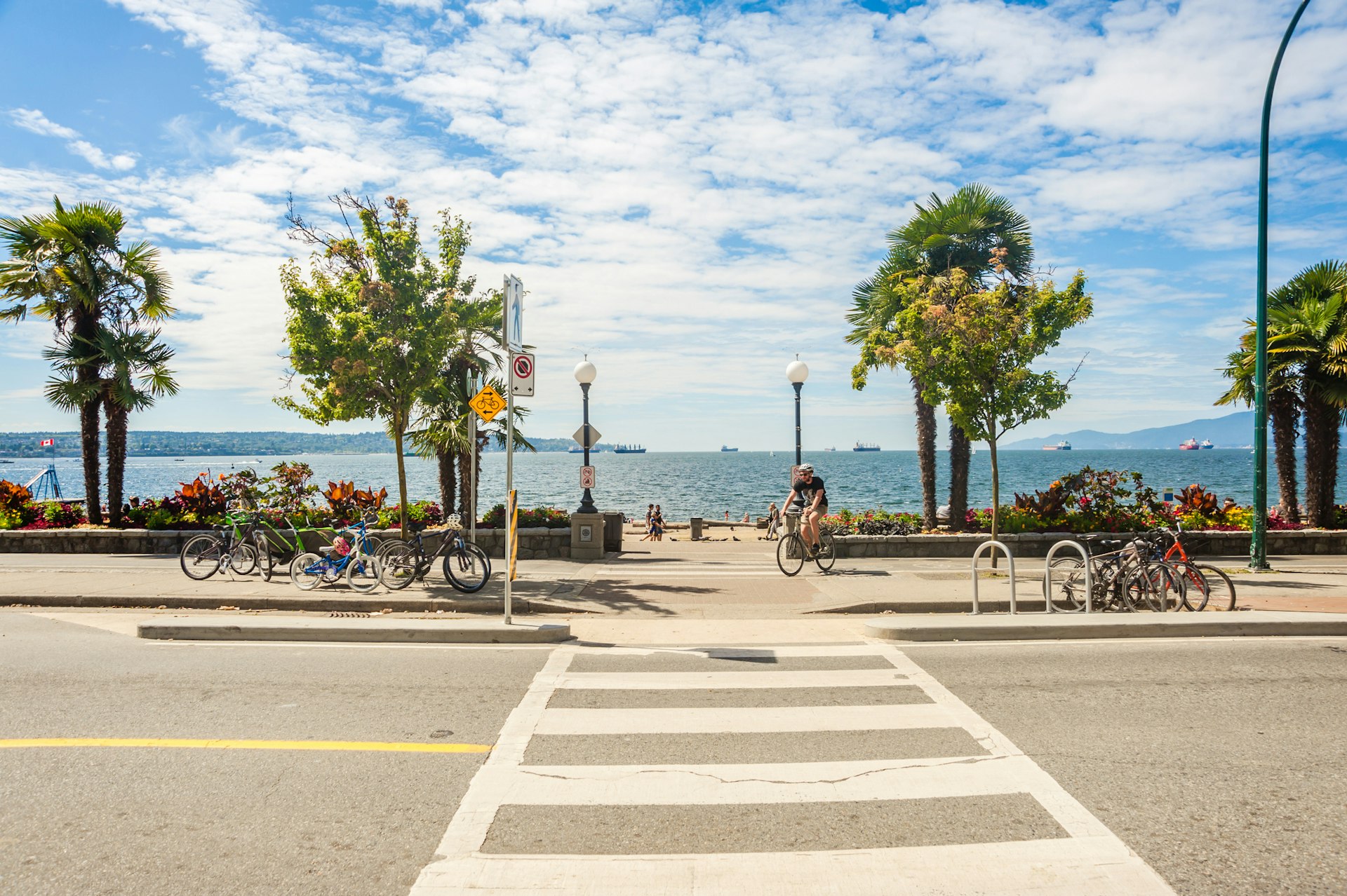 A pedestrian walkway leading to English Bay beach during the summer in the city of Vancouver.
