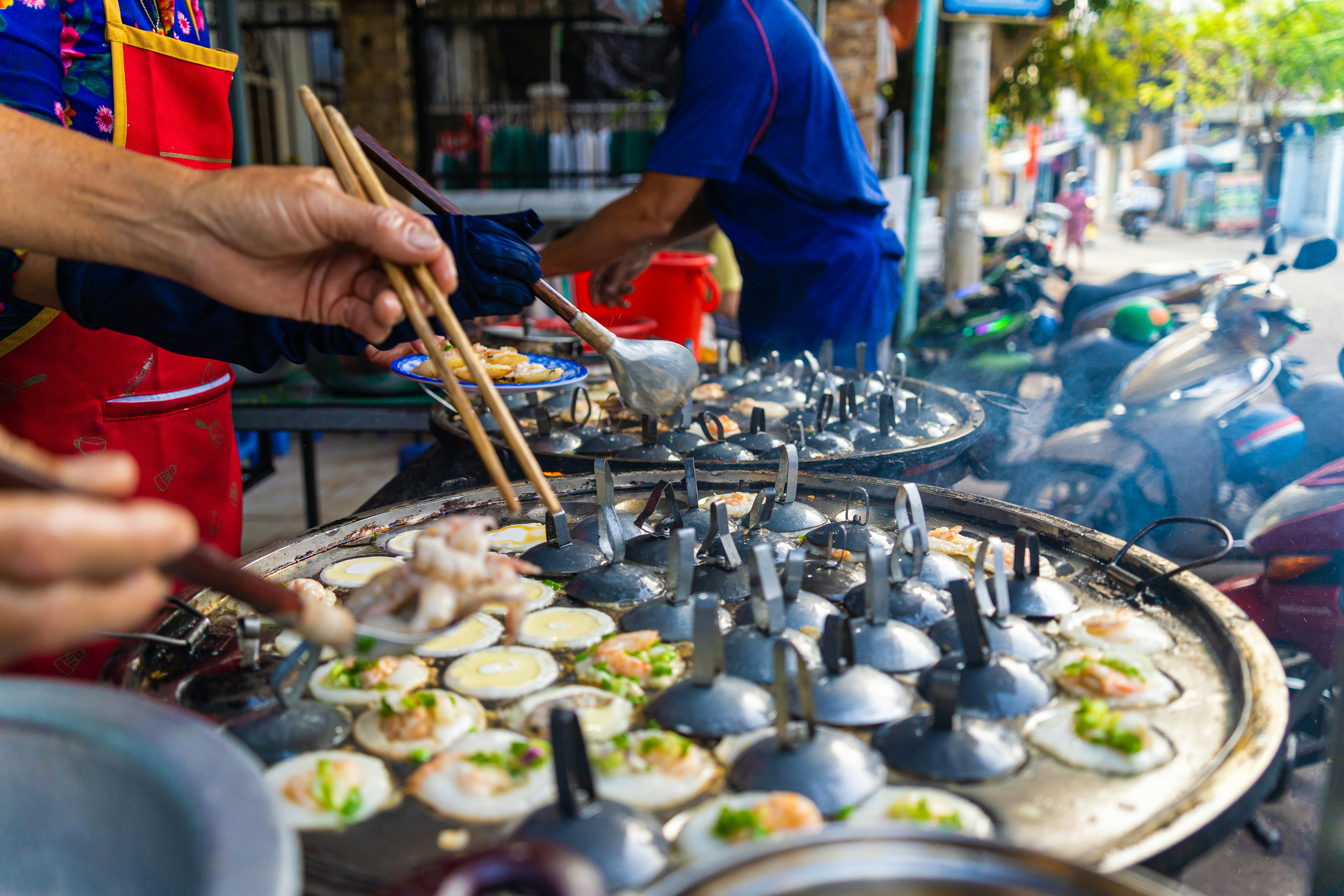 Vietnamese savory mini shrimp pancakes (Banh Khot) with herbs, eggs, shrimps and fish Sauce - Vietnamese cuisine.