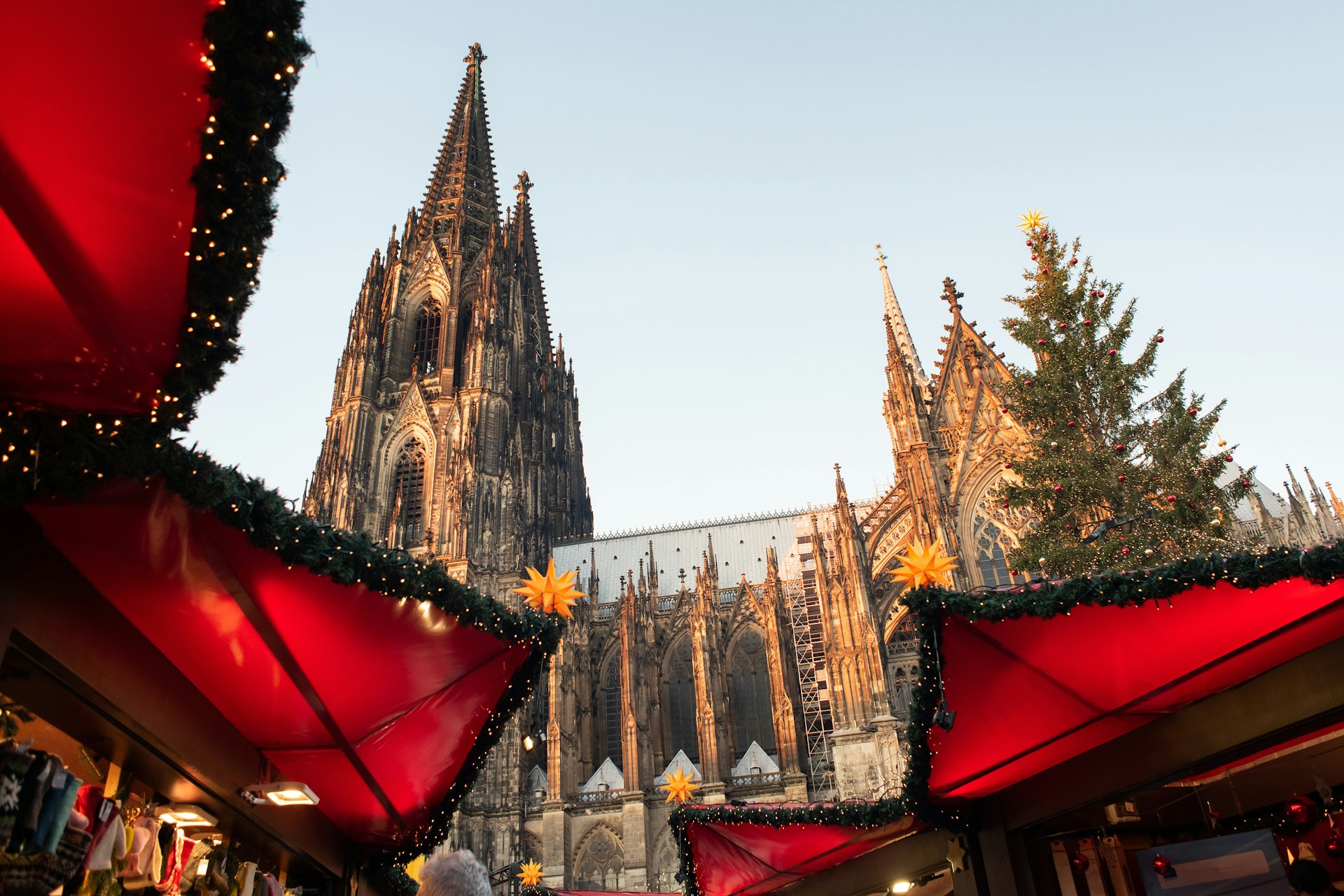 The traditional Christmas market set up in Cologne, Germany, with the cathedral in the background.
