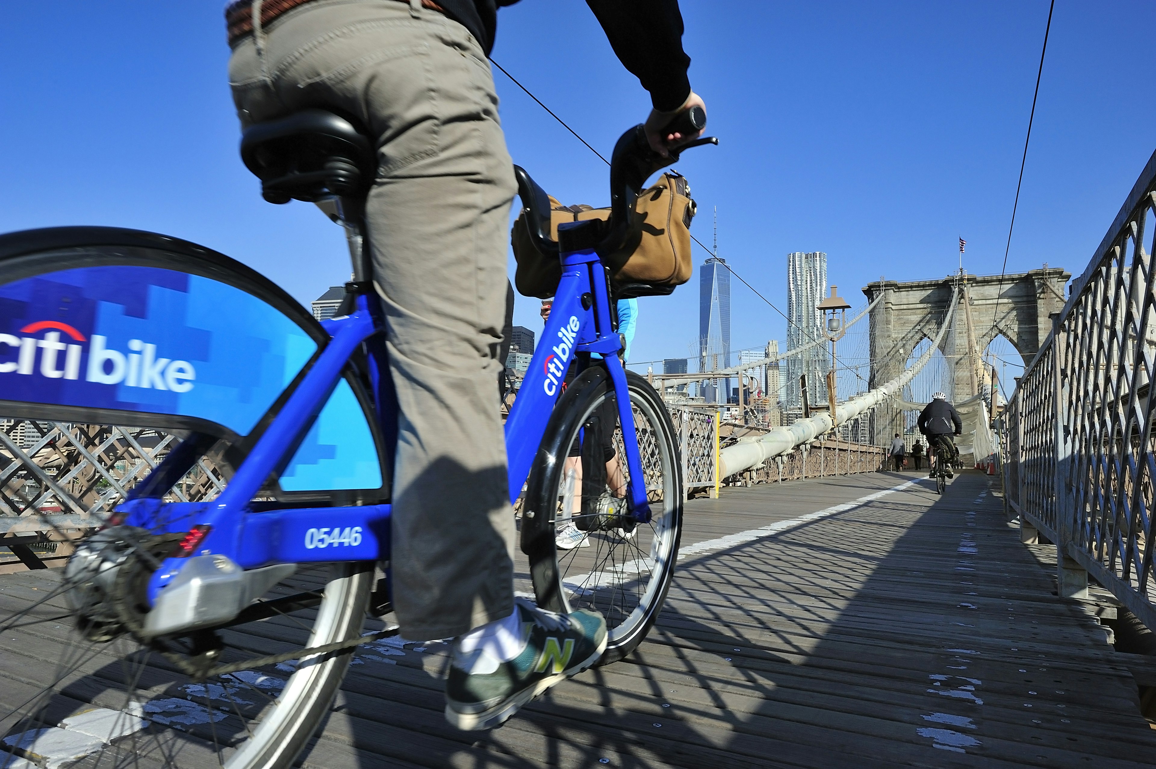 New York City, USA, - May. 19. 2014: Bike riders commuting to Manhattan by Citi Bike over Brooklyn Bridge. New York, USA; Shutterstock ID 213014248; your: Zach Laks; gl: 65050; netsuite: Online Editorial; full: Discover