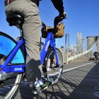 New York City, USA, - May. 19. 2014: Bike riders commuting to Manhattan by Citi Bike over Brooklyn Bridge. New York, USA; Shutterstock ID 213014248; your: Zach Laks; gl: 65050; netsuite: Online Editorial; full: Discover