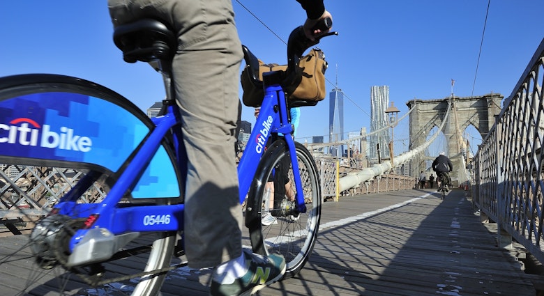 New York City, USA, - May. 19. 2014: Bike riders commuting to Manhattan by Citi Bike over Brooklyn Bridge. New York, USA; Shutterstock ID 213014248; your: Zach Laks; gl: 65050; netsuite: Online Editorial; full: Discover
