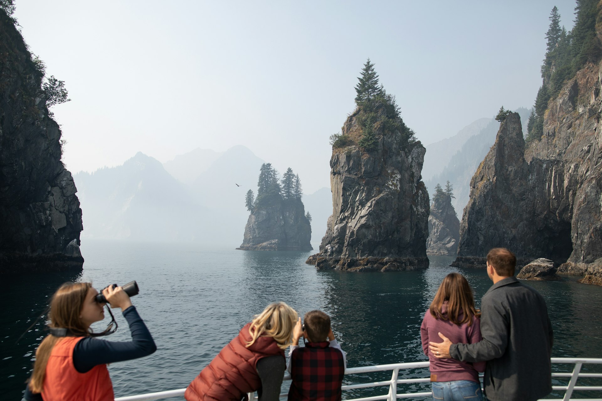 A family spotting wildlife among the cliffs of Kenai Fjords National Park 
