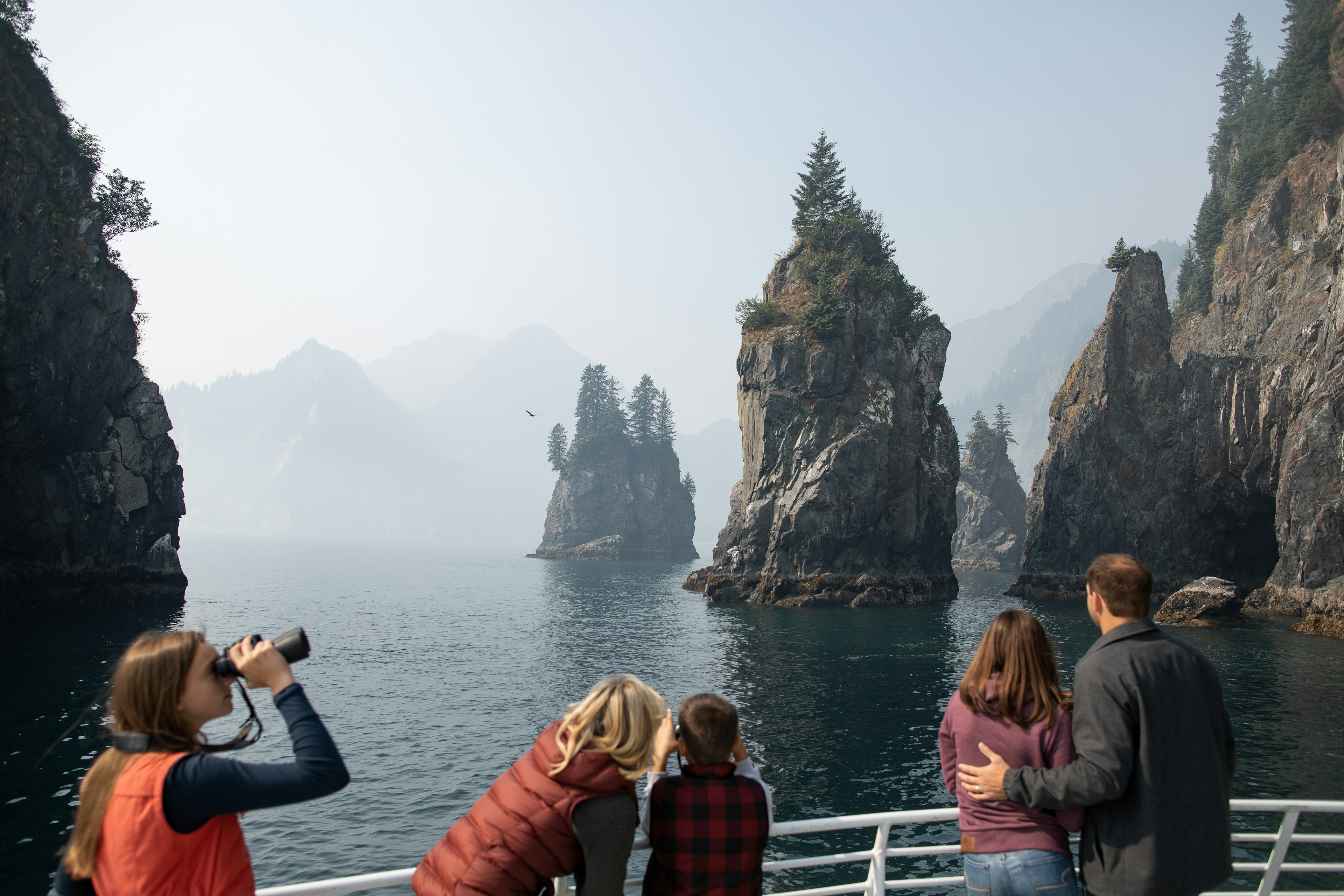 A family spotting wildlife among the cliffs of Kenai Fjords National Park