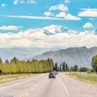 Mendoza, Argentina - February 13, 2013: Vehicles driving through the road and the view of the landscape near Mendoza, Argentina.