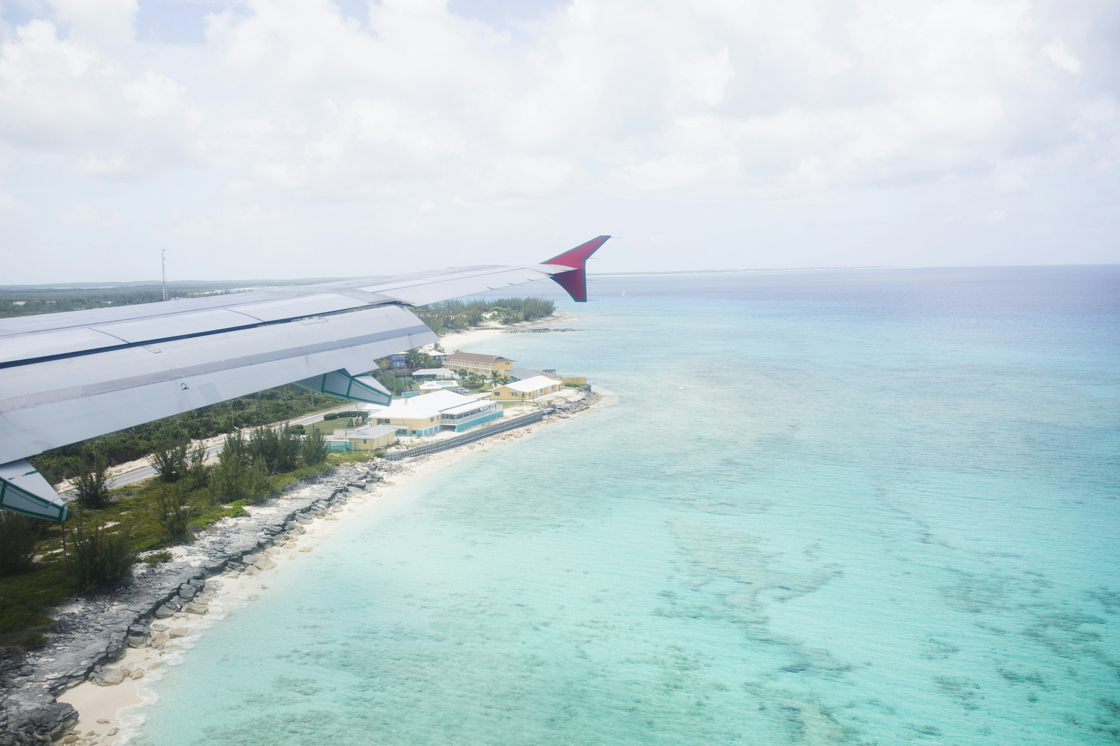 Aerial view of a flight passing over San Salvador island and turquoise waters