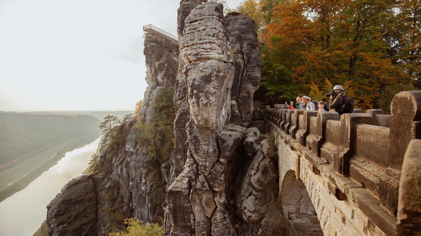 Visitors look out from Bastei near Dresden © Elizaveta Kovaleva/Lonely Planet