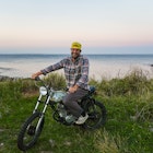Dean Petty rides his motorcycle along the coast of Nova Scotia © Jack Pearce/Lonely Planet
