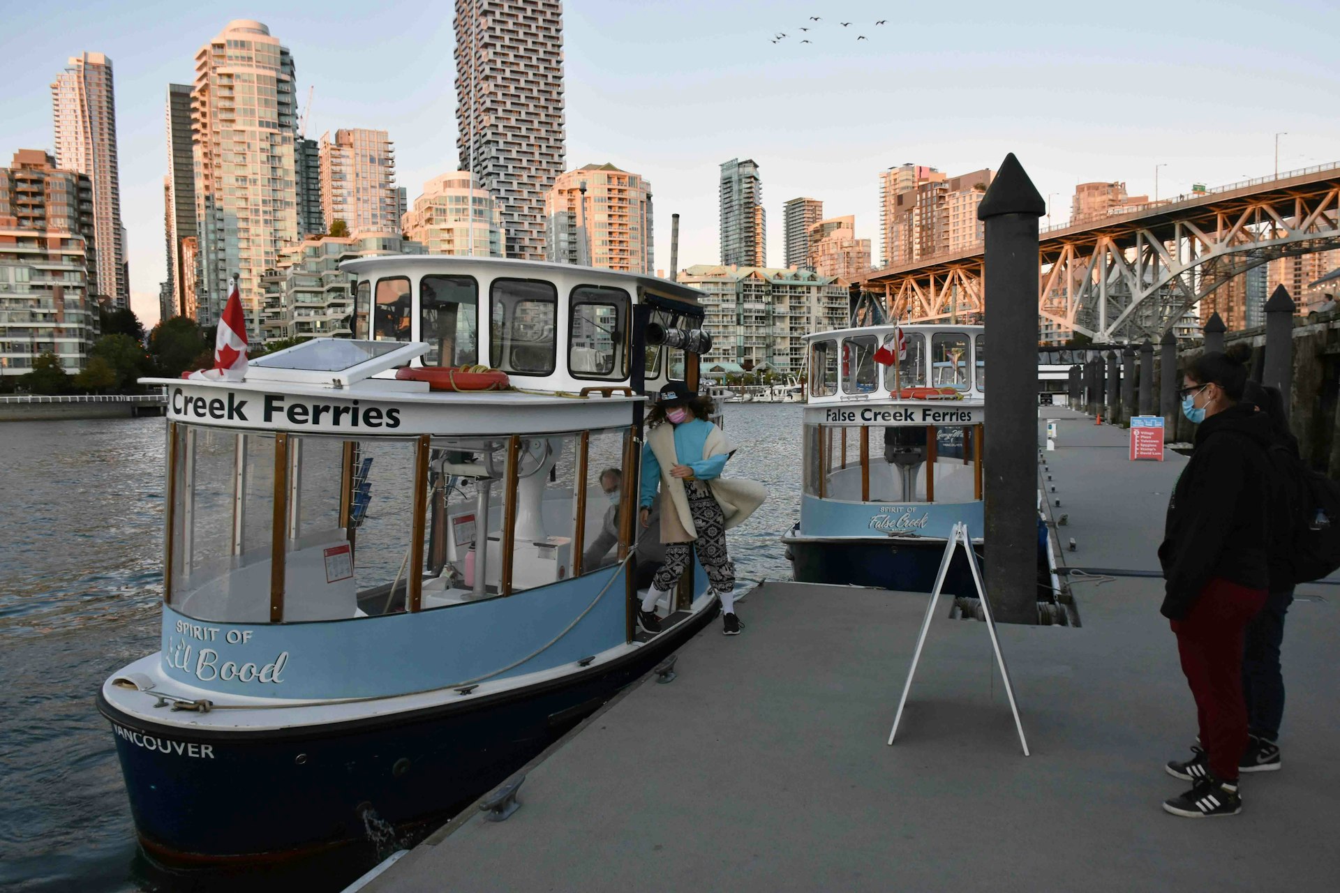 People waiting for a recreational boat at Vancouver’s Granville Island, in British Columbia, Canada