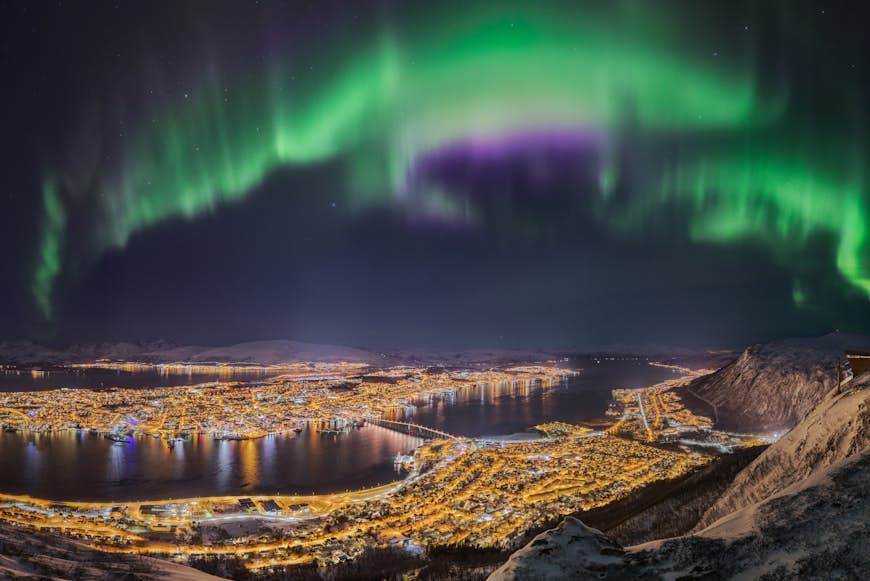 Northern lights dance over the city of Tromsø, Norway