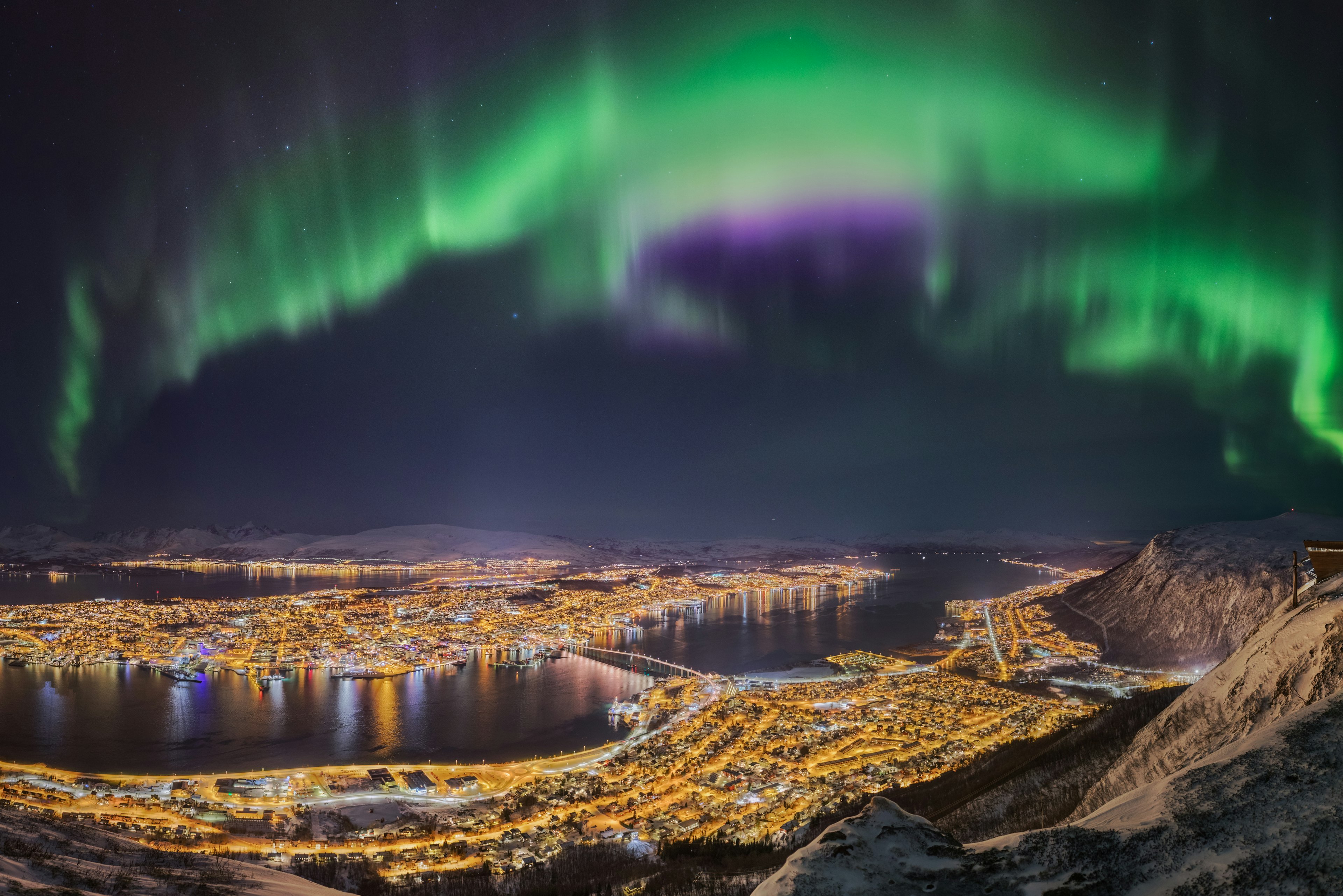 Northern lights dance over the city of հǳø, Norway