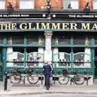 The Glimmer Man Pub in Stoneybatter,Dublin, Ireland the interior walls are covered in old photos, paintings,memorabilia and old drink company signage.