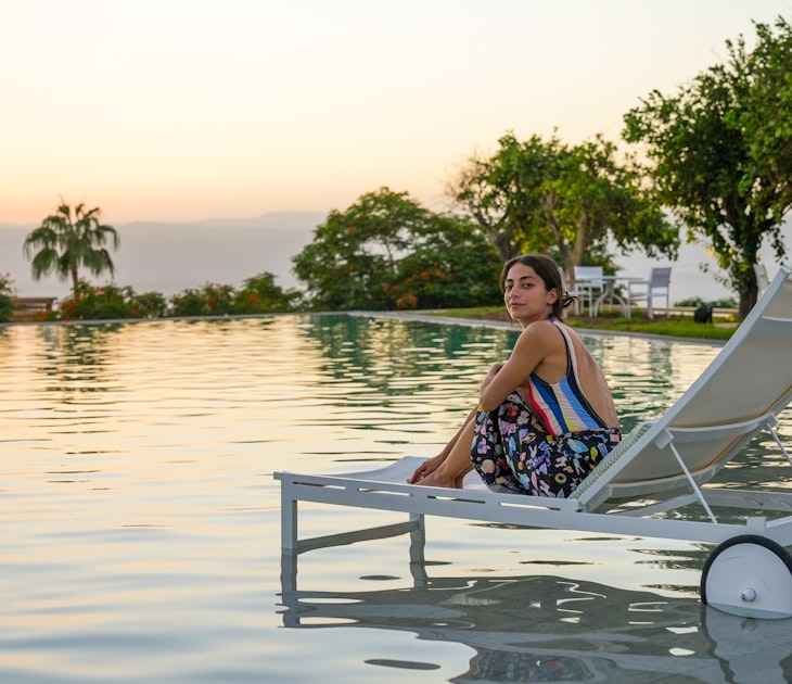 Tania George relaxes by the pool in Kempinski, Jordan © Jack Pearce/Lonely Planet