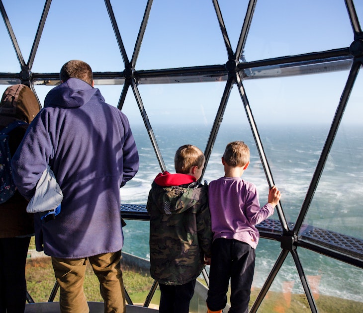 A family looks out of the Mull of Galloway's lighthouse © Emily Macinnes/Lonely Planet
