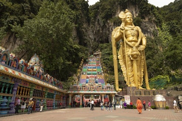 Batu Caves, Malaysia - Nov 04, 2019: Access area and entrance to the stairs to the Batu Caves, guarded by the huge Sri Muruga statue, Gombak District, Selangor, Malaysia