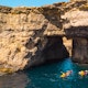 Group of kayakers under cave. Comino island. Drone landscape. Europe. Malta country