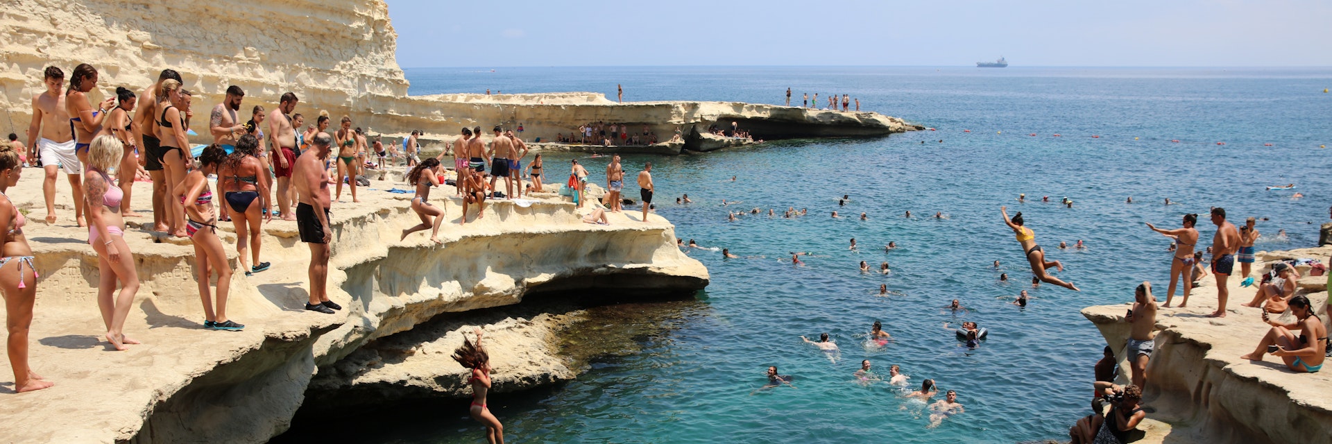 Marsaxlokk, Malta – August 13, 2019: St. Peter's Pool near Marsaxlokk. A very popular place for Locals and Tourists. Malta