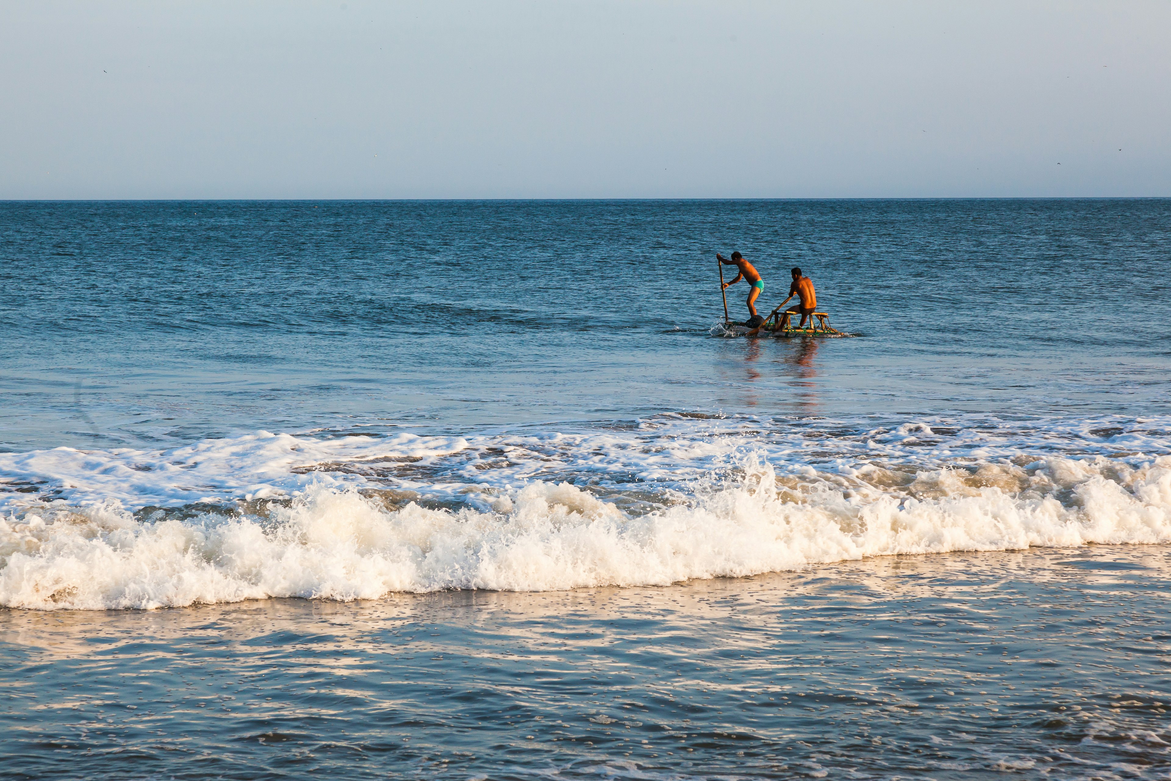 Artisanal fishermen in their raft, returning with their work to the coast in Mancora