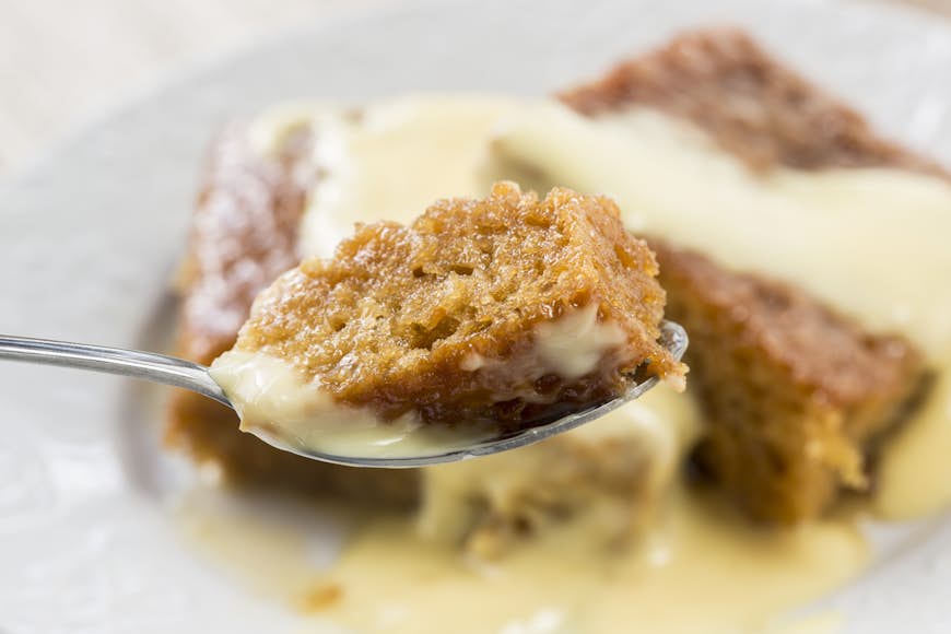 Spoonful of malva pudding, a South African dessert of sponge cake with caramelized butter sauce