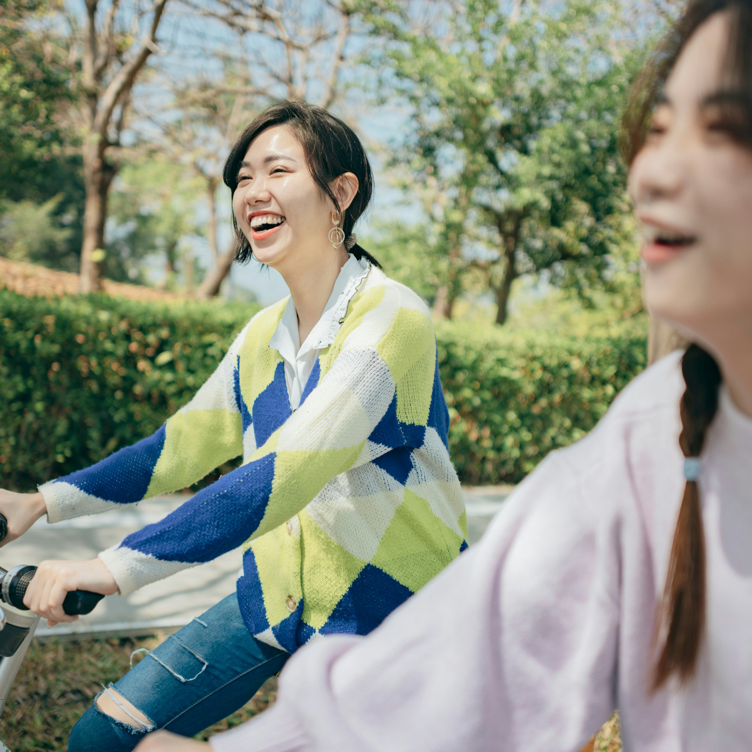 Two asian women renting bicycles to travel in the city