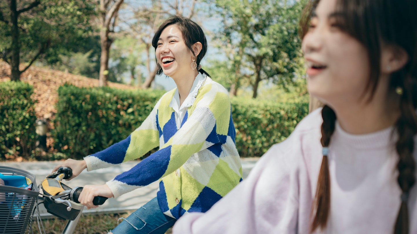Two asian women renting bicycles to travel in the city