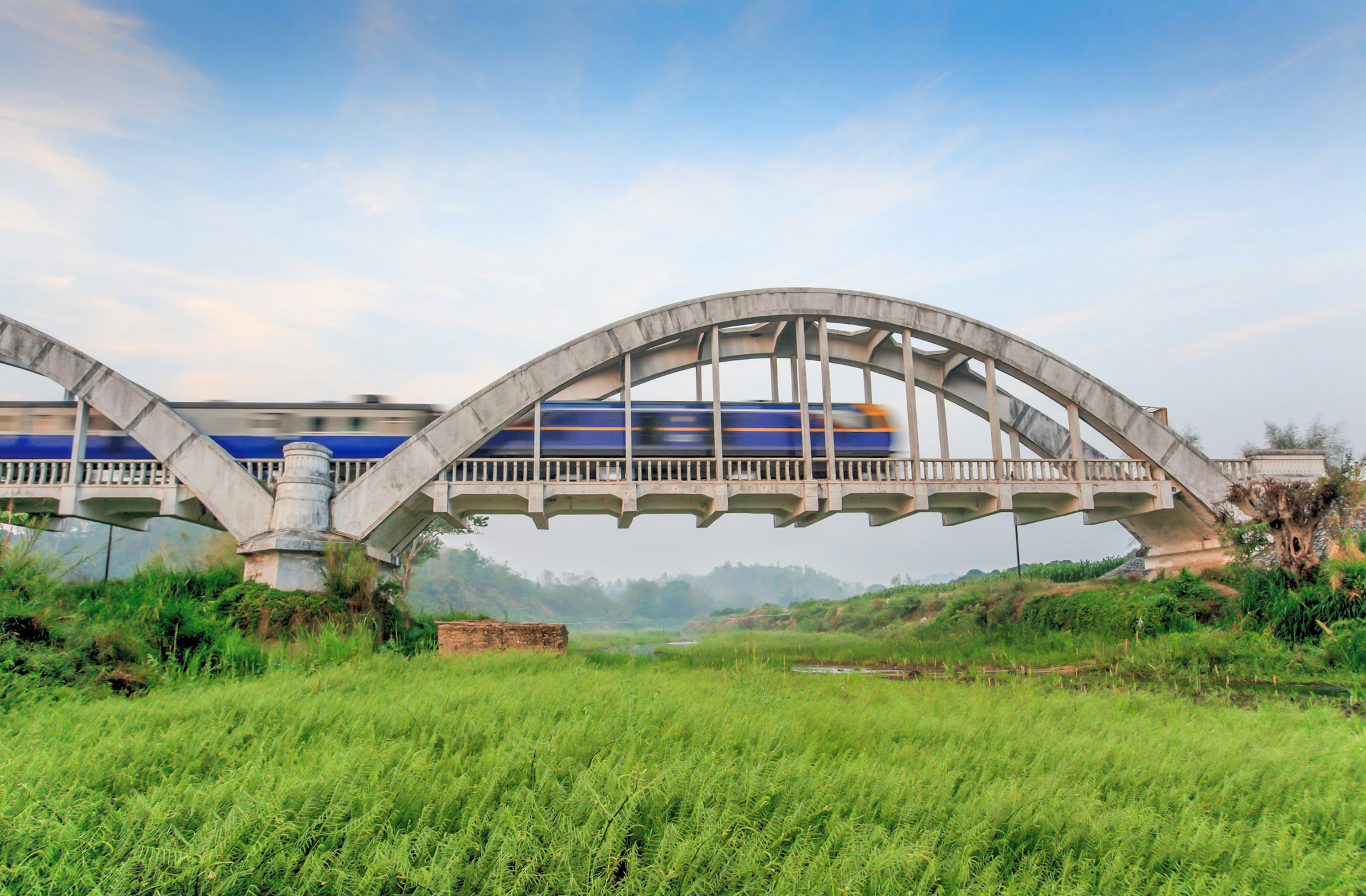 Old train crossing Tha Chomphu Bridge in Lamphun Province. Old white bridge. Northern