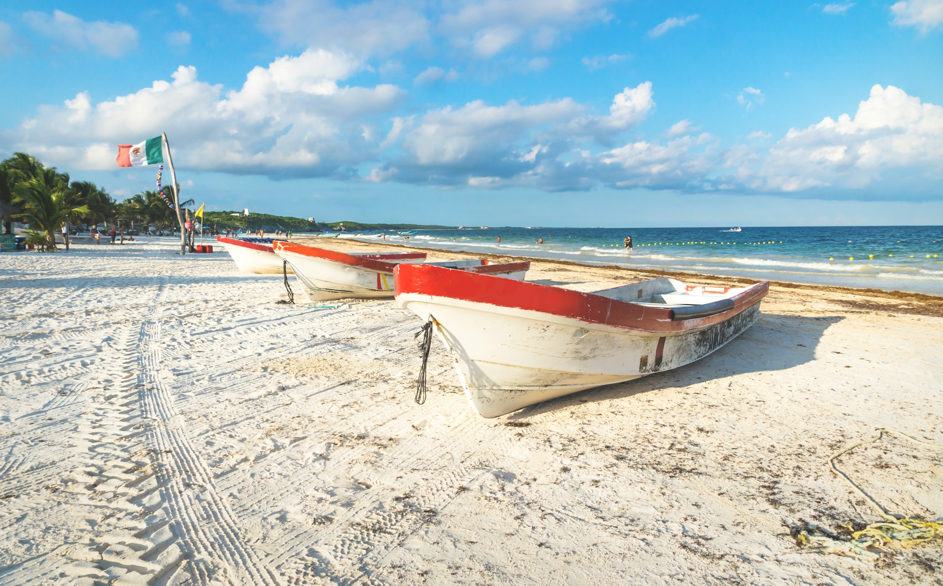 Boats at Playa Pescadores with blue sky and cloudscape