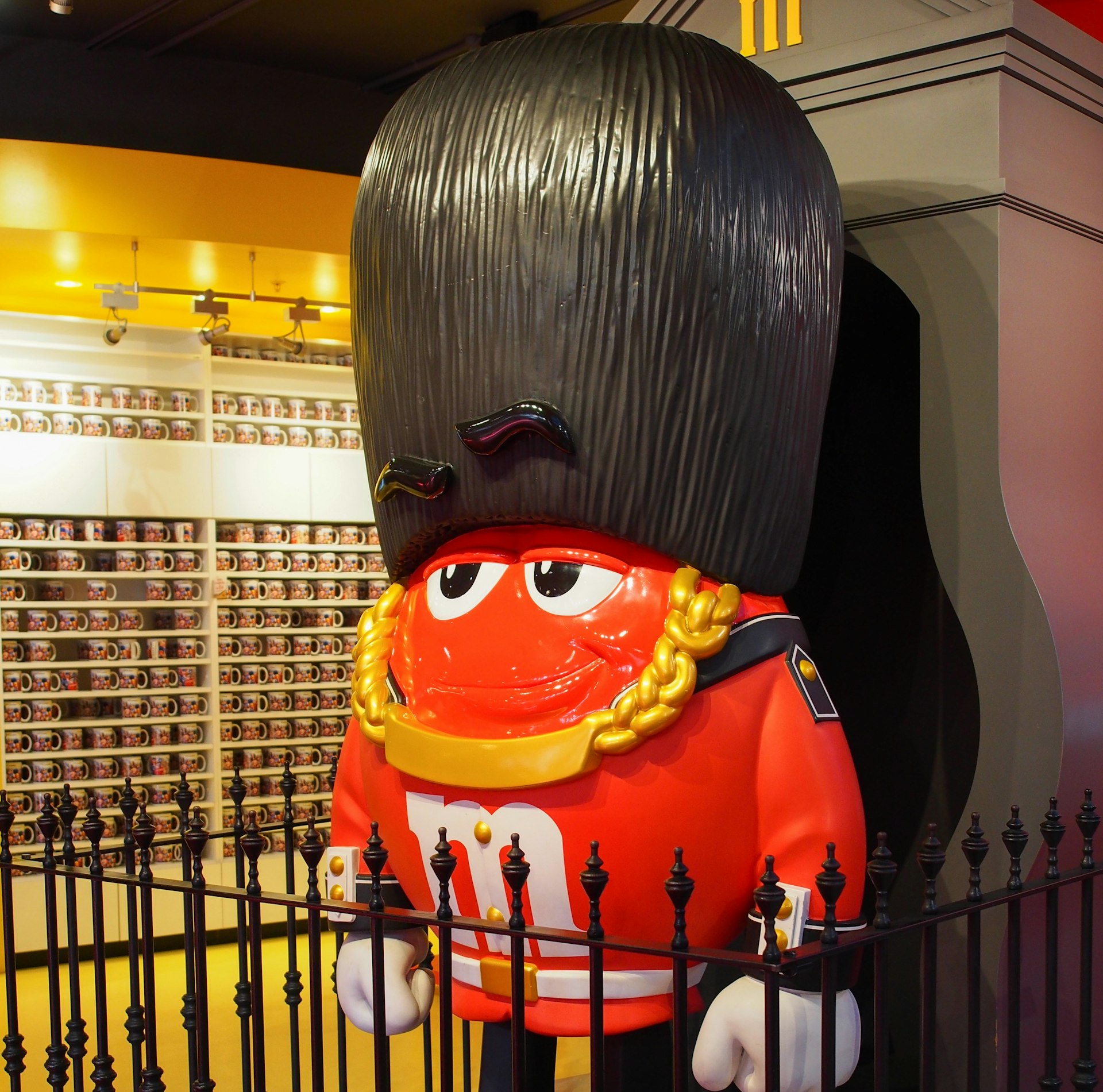 A life-sized red M&M figurine in a King’s Guard costume at M&M’s London store, London, England, United Kingdom