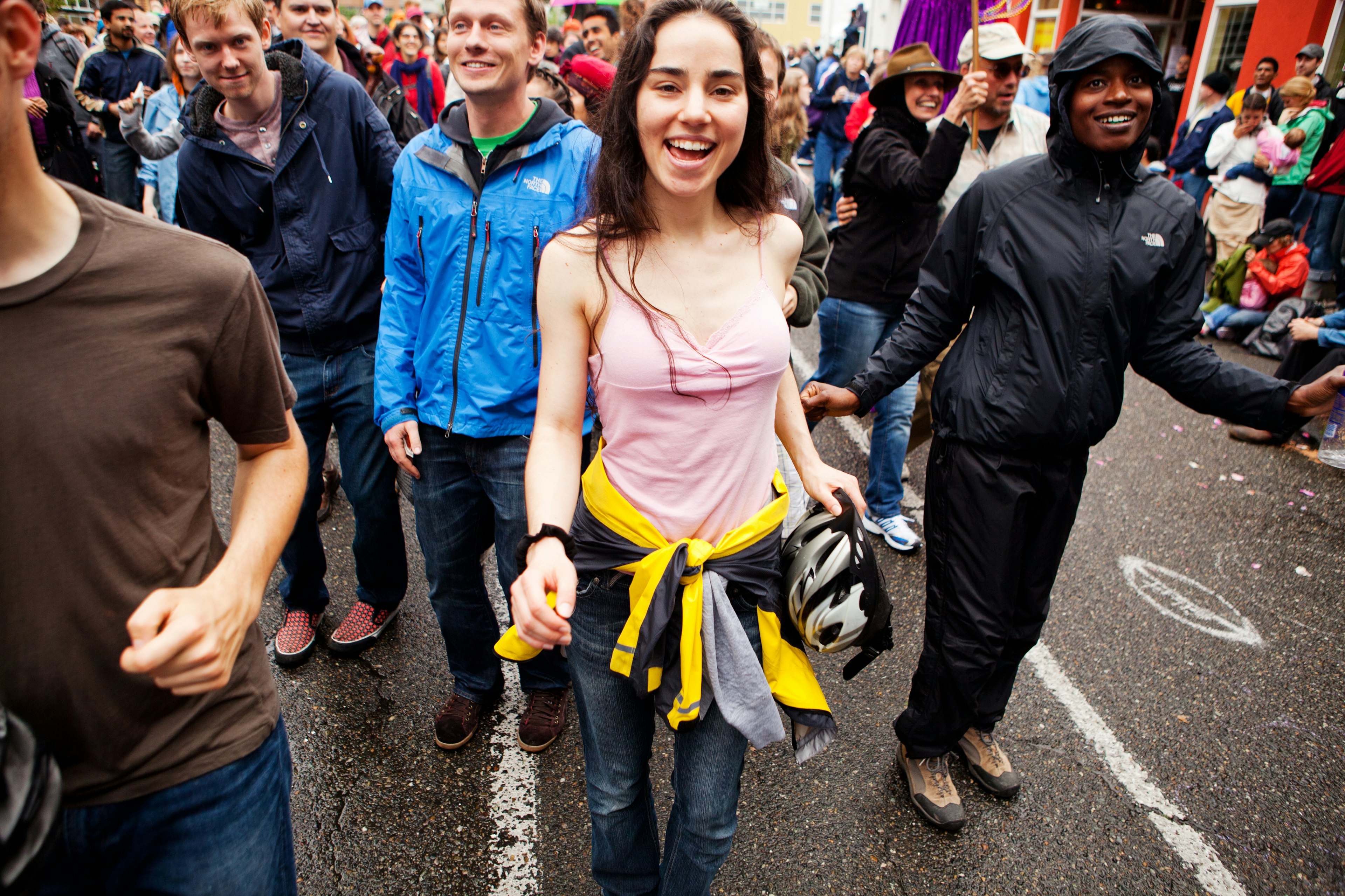 People  dancing and having fun during the summer solstice parade.  Crowds of people lined the streets for the 2011 summer solstice parade, which is part of the Fremont Fair.