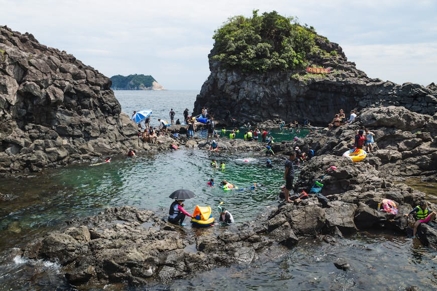 Natural Pool with a crowd of tourists and locals swimming.