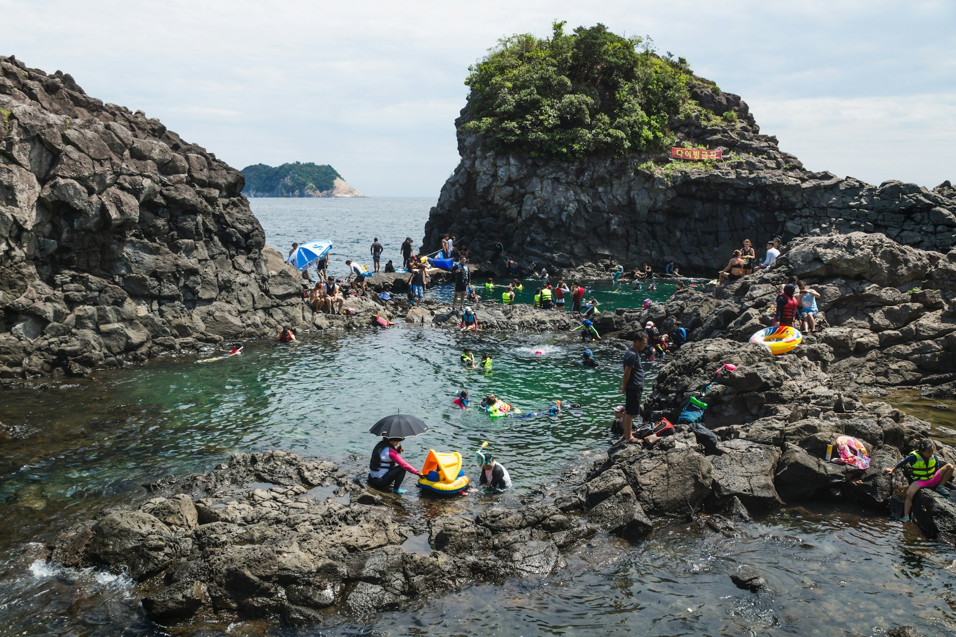 Natural Pool with a crowd of tourists and locals swimming.