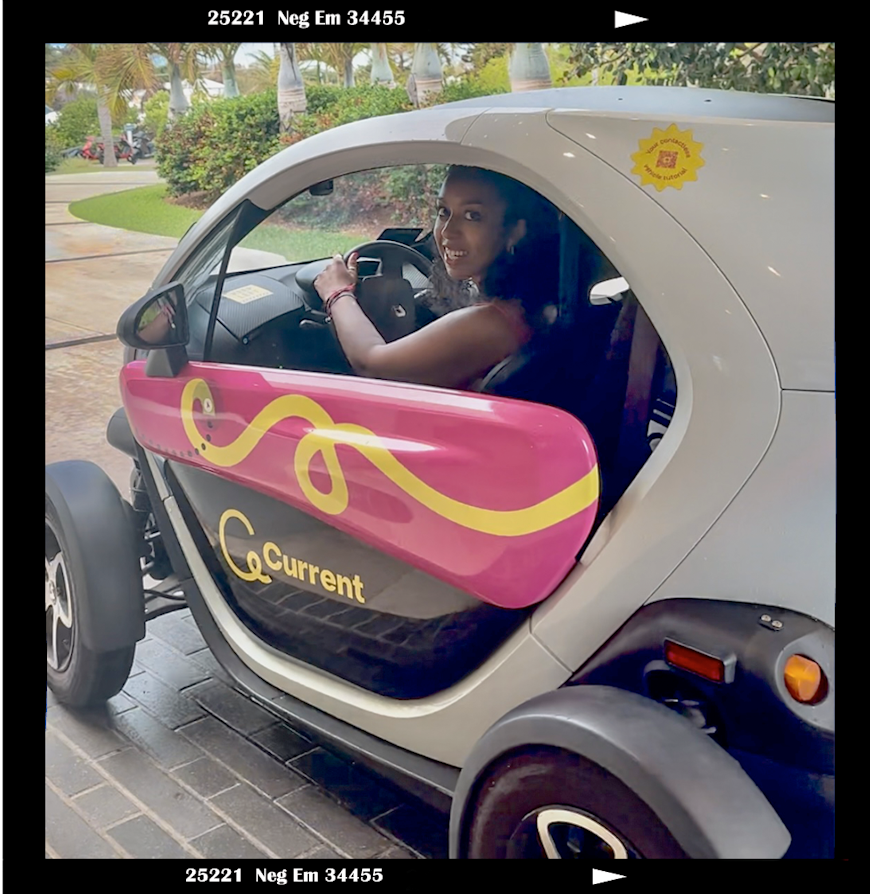 Georgina behind the wheel of an electric car in Bermuda
